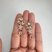 Load and play video in Gallery viewer, 6 x 8 mm. Oval Cut Yellow Brazilian Beryl and Morganite with Zircon and Sapphire Accents Cluster Drop Earrings
