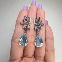 Load and play video in Gallery viewer, 10 x 14 mm. Pear Cut Sky Blue Brazilian Topaz and Sapphire with Cz Accents Drop Earrings (Blemished)
