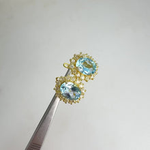 Load and play video in Gallery viewer, 7 x 9 mm. Oval Cut Sky Blue Brazilian Topaz with Cz Accents Earrings
