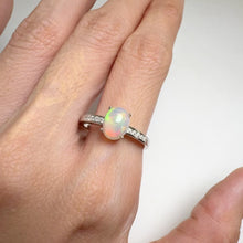 Load and play video in Gallery viewer, 6 x 8 mm. Oval Cabochon Multi-coloured Ethiopian Opal with Cz Accents Ring
