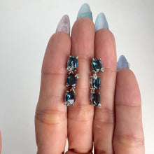 Load and play video in Gallery viewer, 5 x 7 mm. Oval Cut London Blue Brazilian Topaz with Cz Accents Drop Earrings
