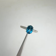 Load and play video in Gallery viewer, 6 x 8 mm. Oval Cut London Blue Brazilian Topaz with Cz Accents Ring
