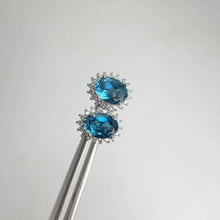 Load and play video in Gallery viewer, 5 x 7 mm. Oval Cut London Blue Brazilian Topaz with Cz Accents Earrings
