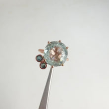 Load and play video in Gallery viewer, Handmade 11 x 12 mm. Oval Cut Blue Brazilian Aquamarine with Sapphire Accents Ring
