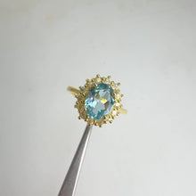 Load and play video in Gallery viewer, 7 x 9 mm. Oval Cut Sky Blue Brazilian Topaz with Cz Accents Ring
