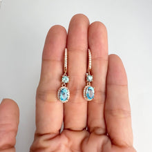 Load and play video in Gallery viewer, 5 x 7 mm. Oval Cut Sky Blue Brazilian Topaz with Cz Halo Drop Earrings
