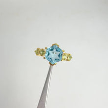 Load and play video in Gallery viewer, Handmade 9 mm. Carved Star Hexagon Cut Swiss Blue Brazilian Topaz with Peridot Accents Ring
