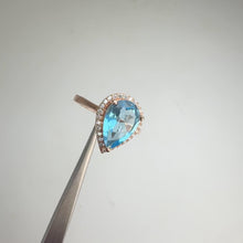 Load and play video in Gallery viewer, 8 x 12 mm. Pear Cut Sky Blue Brazilian Topaz with Cz Halo Ring
