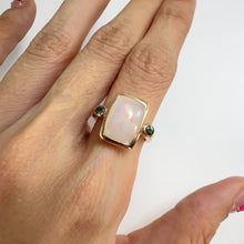 Load and play video in Gallery viewer, Handmade 9 x 13 mm. Cushion Cabochon Multi-coloured Ethiopian Opal with Sapphire Accents Ring
