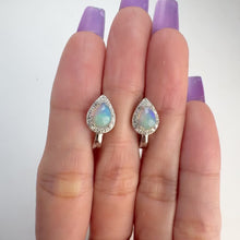 Load and play video in Gallery viewer, 5 x 7 mm. Pear Cabochon Multi-coloured Ethiopian Opal with Cz Halo Earrings
