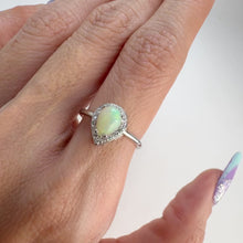 Load and play video in Gallery viewer, 5 x 7 mm. Pear Cabochon Multi-coloured Ethiopian Opal with Cz Halo Ring
