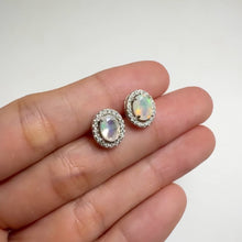 Load and play video in Gallery viewer, 5 x 7 mm. Oval Cut Multi-coloured Ethiopian Opal with Cz Halo Earrings
